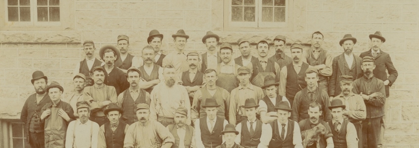 Photo of workers at Sleeman factory with photobomber in background