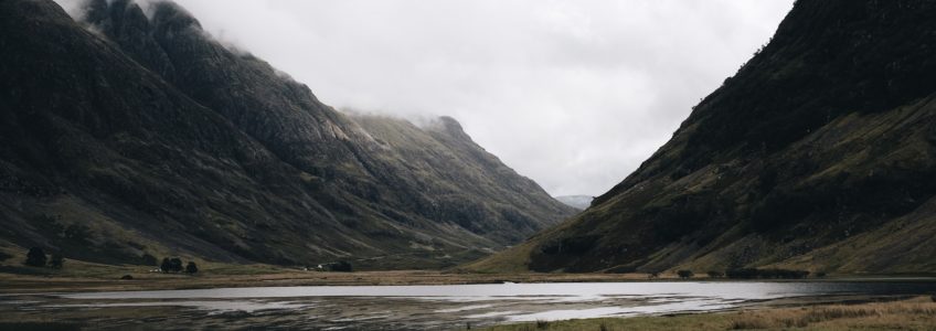 Stock photo of a lake and valley in Scotland. The skies are grey.