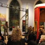 Storyteller presenting to a large group in the Families Gallery