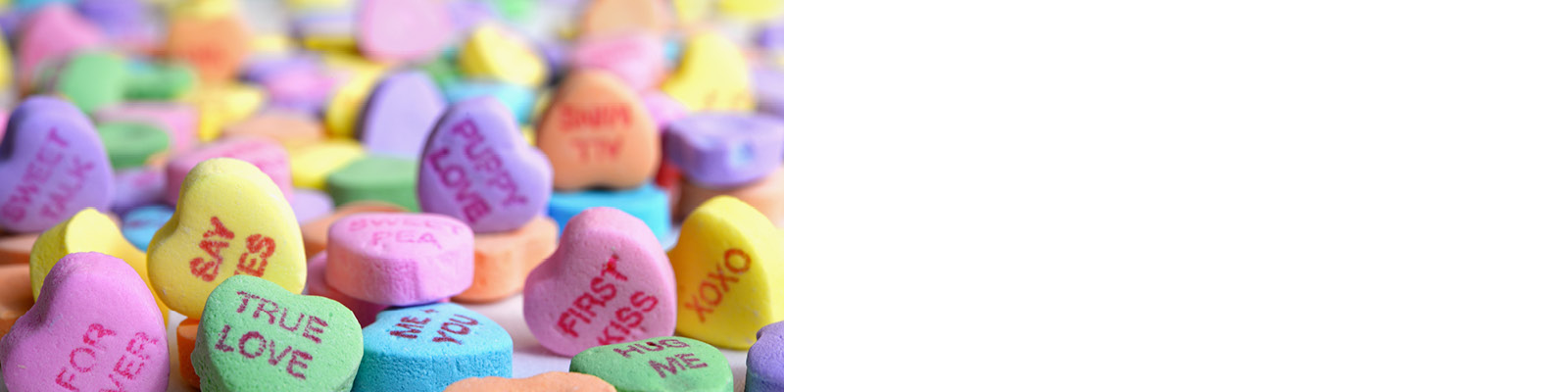 Photo of assorted candy hearts on the left. White block to the right.