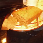 Kens Ginger Bread demonstration - slicing the golden brown loaf on a plate