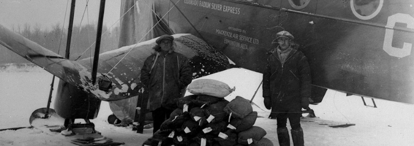Figure 9.15 In April 1935, W.L. Britnell and Stan McMillan unload the first shipment of uranium concentrate from the Northwest Territories. The photo is good, but everyone in it was overexposed.
