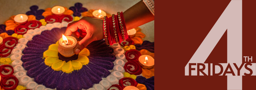 Diwali celebration. Person placing a candle in the centre of flowers.