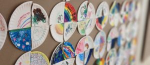Community Quilt activity. Colourful plates have been drawn on by students and are hanging on the wall.
