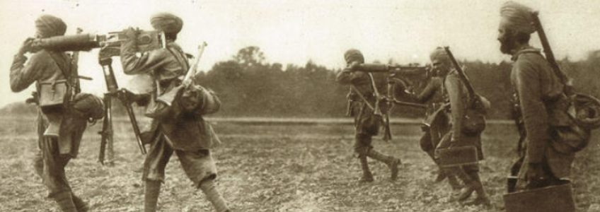 A group of Sikh Soldiers in the Great War. They are running through a field carrying items.